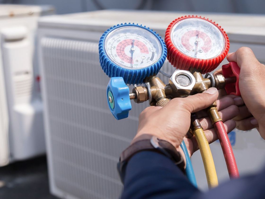 HVAC technician servicing residential HVAC unit