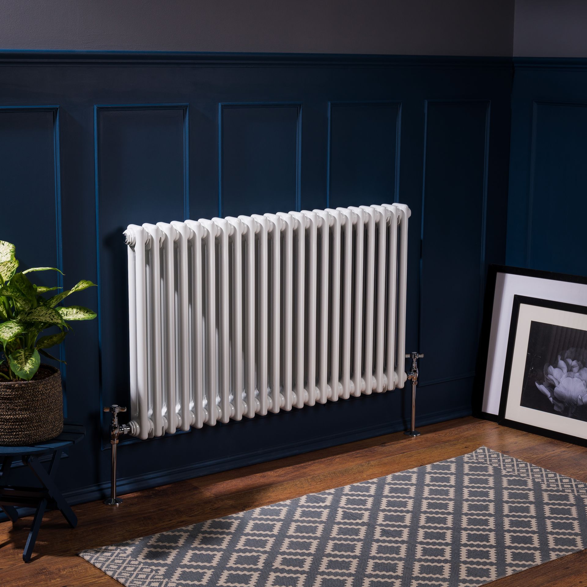 A white radiator is sitting in a living room next to a rug.