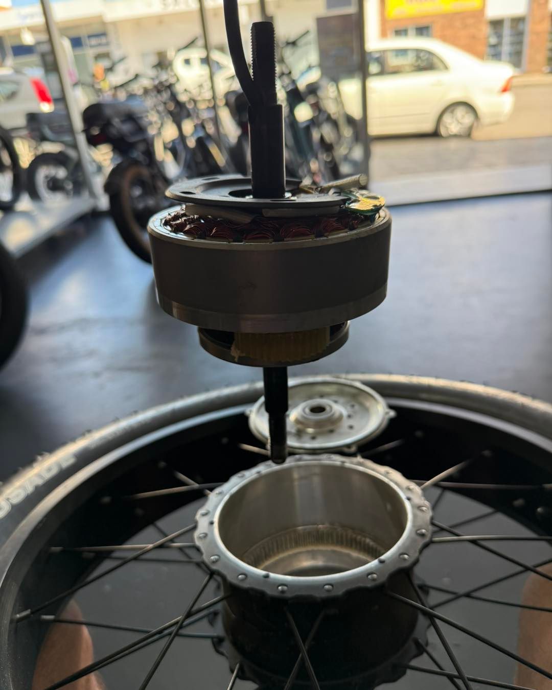 Electric Bike Wheel With Exposed Motor Components Being Assembled — E-Go-Try-Bikes in Nelson Bay, NSW