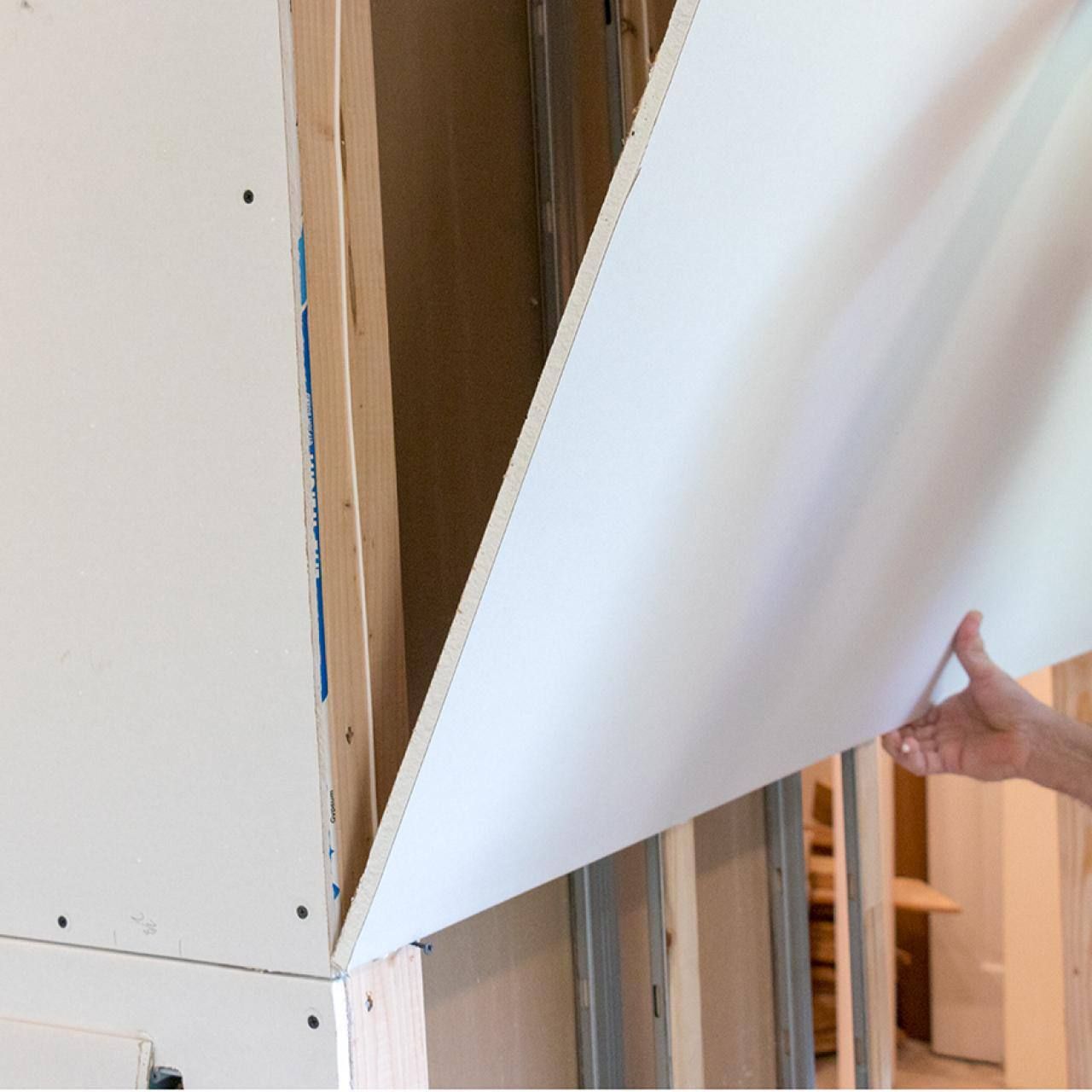 A person is holding a piece of white board in their hand