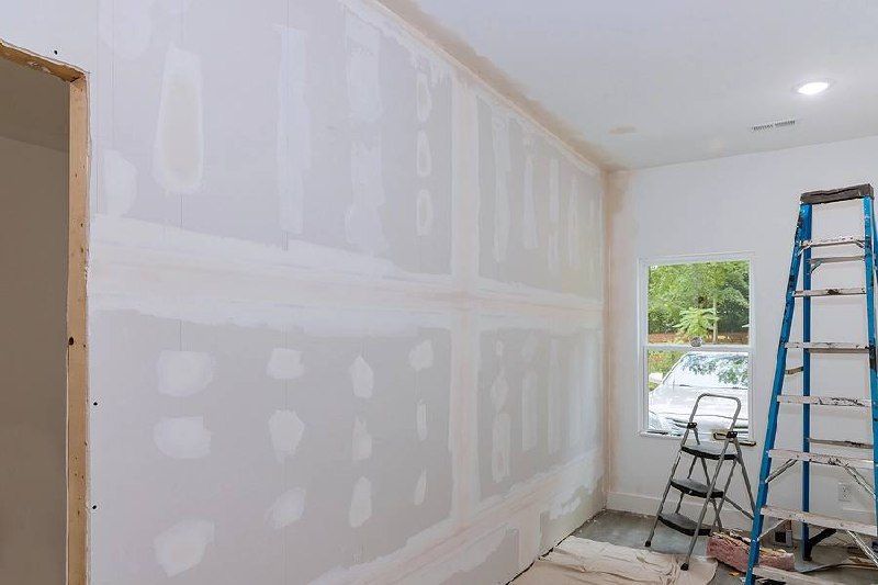 A room is being remodeled with drywall and a ladder.
