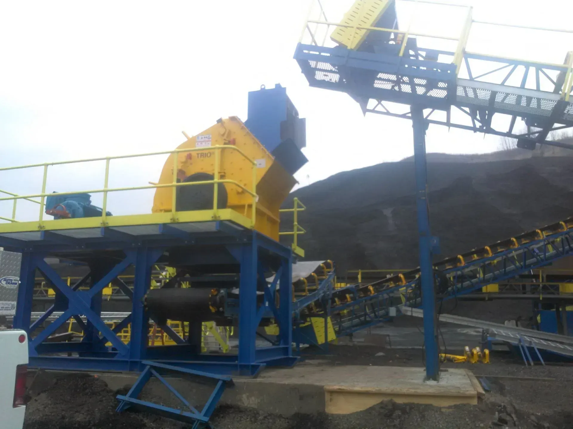 A blue and yellow machine with a yellow railing.