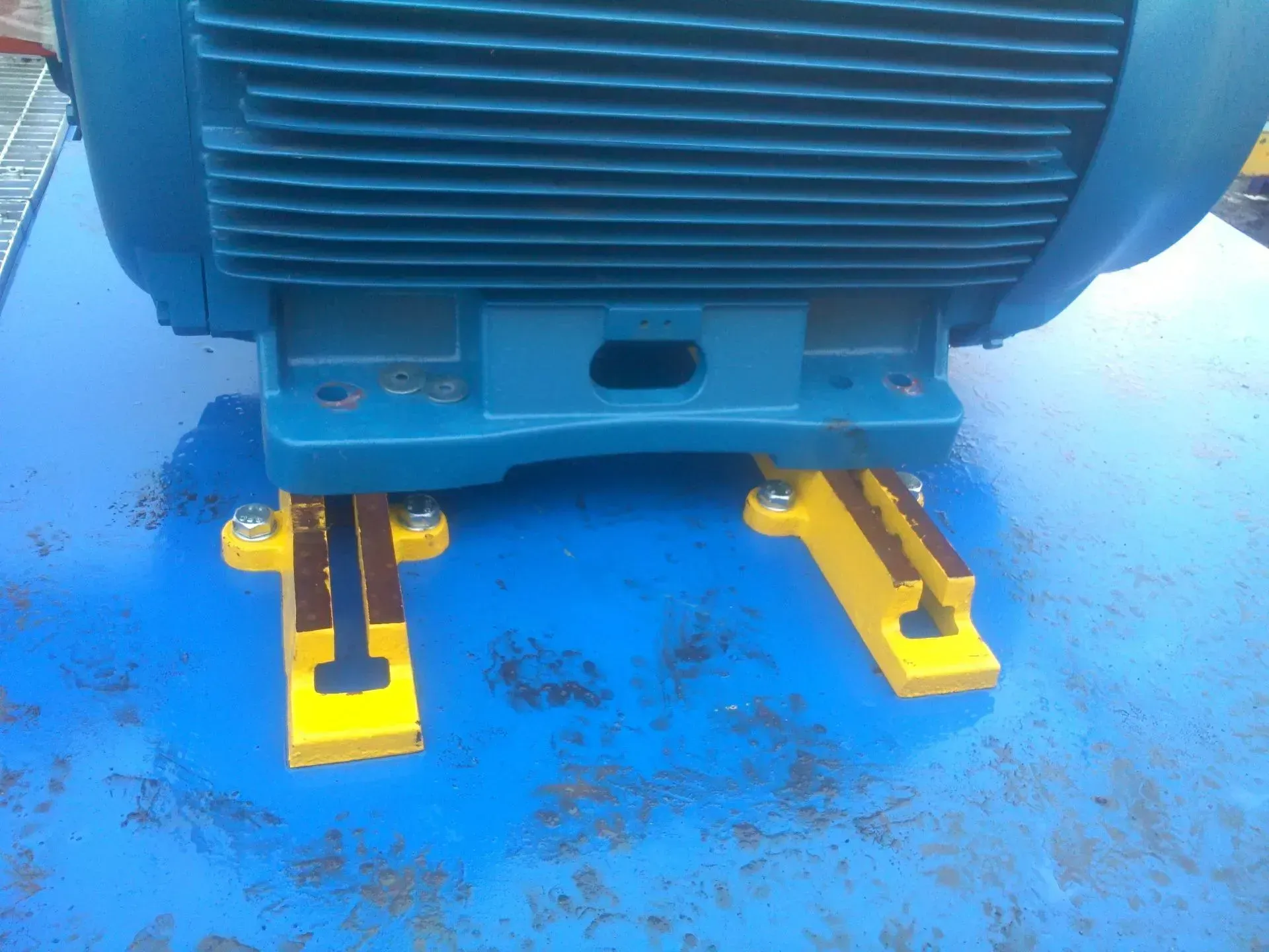 A blue motor is sitting on top of a blue table.