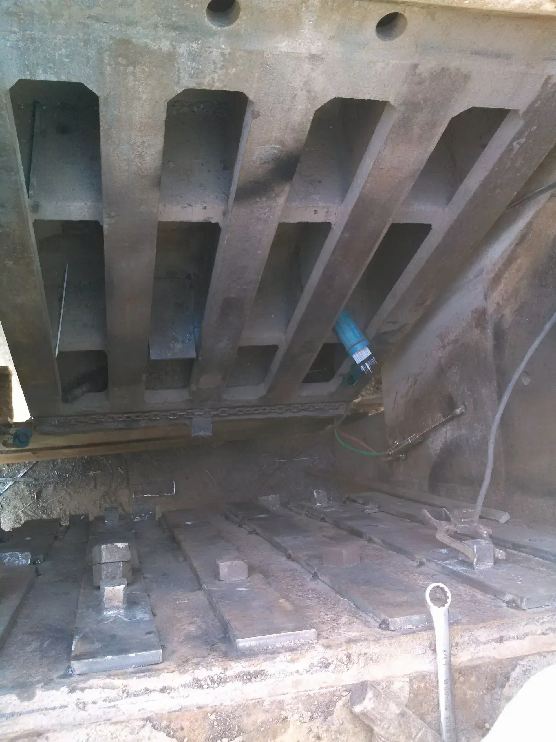 A metal structure with a blue pipe coming out of it.