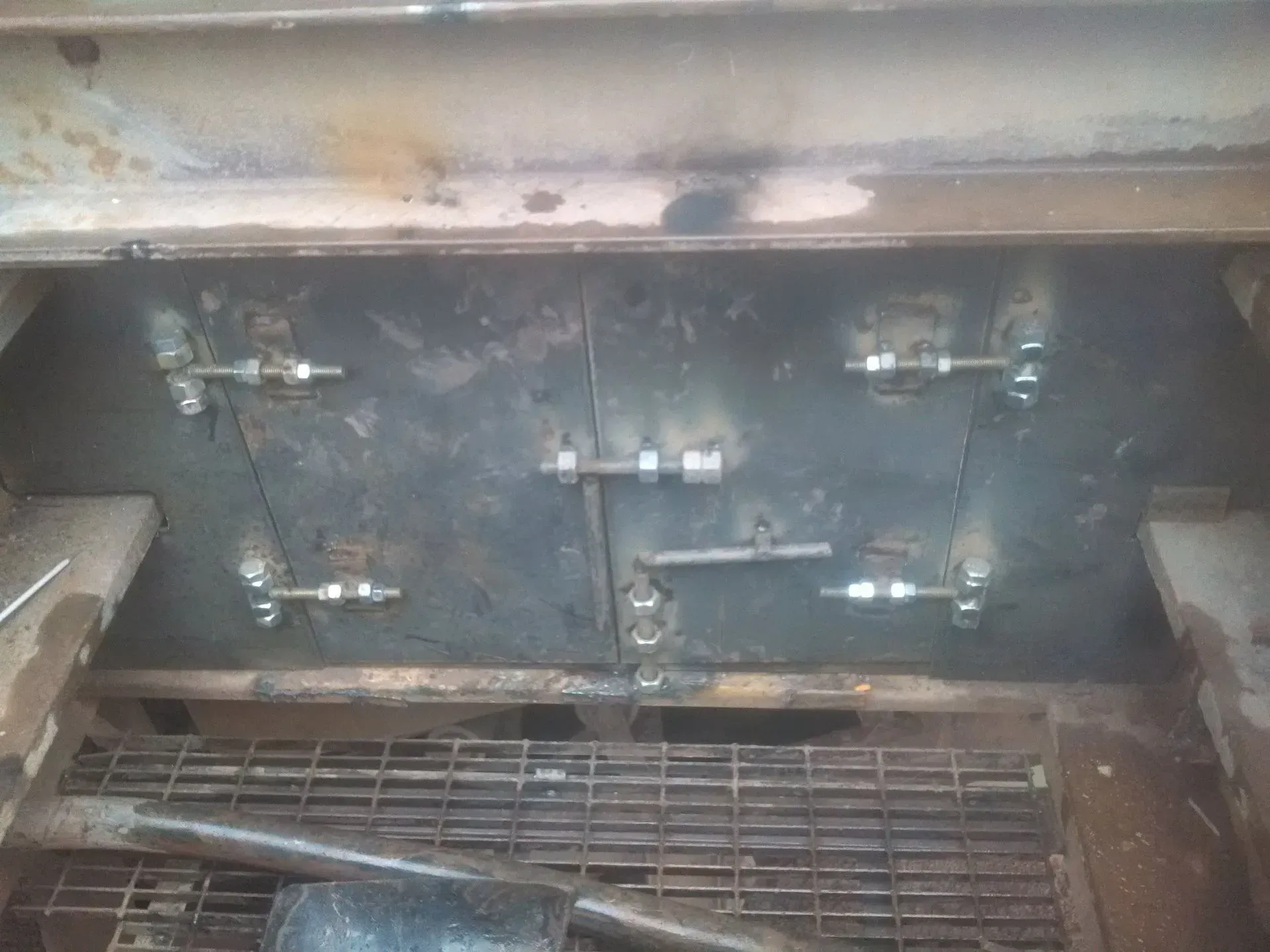 A close up of a metal item with a shovel in it.