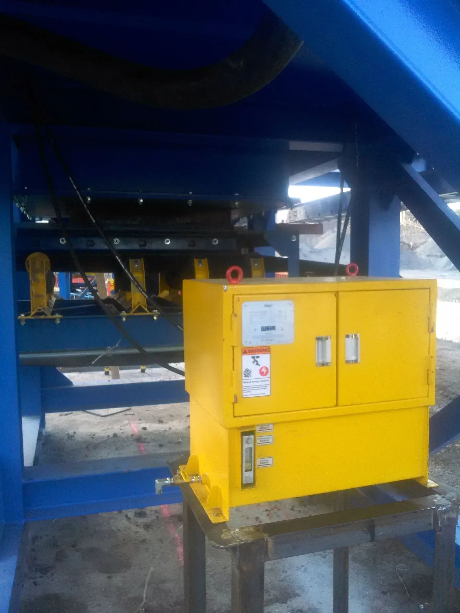 A yellow machine box with a warning label on it.