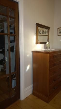There is a dresser and a mirror in the room.