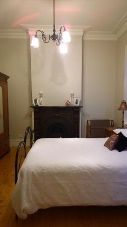 A bedroom with a fireplace and a bed