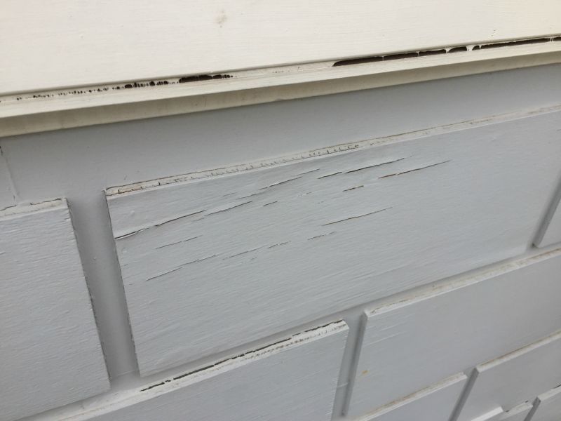 A close up of a white brick wall with a white trim.