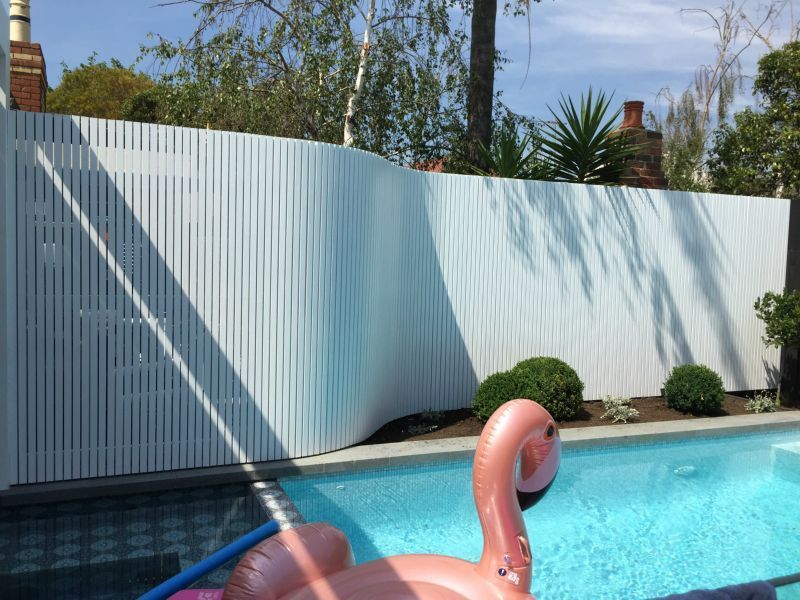 A pink flamingo float is floating in a swimming pool
