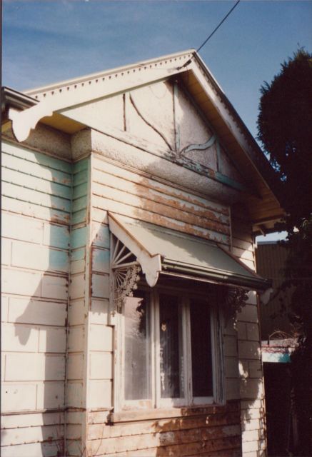 A white house with a window and a roof