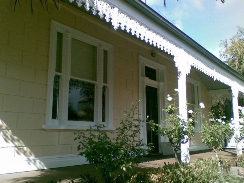 The front of a house with a porch and white trim
