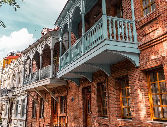 A brick building with a balcony on the side of it