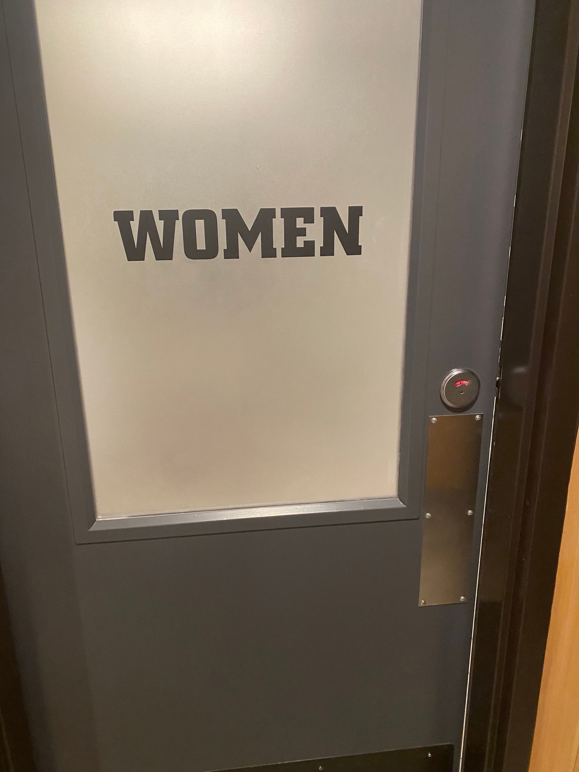 Women restroom door with frosted glass and metal handle
