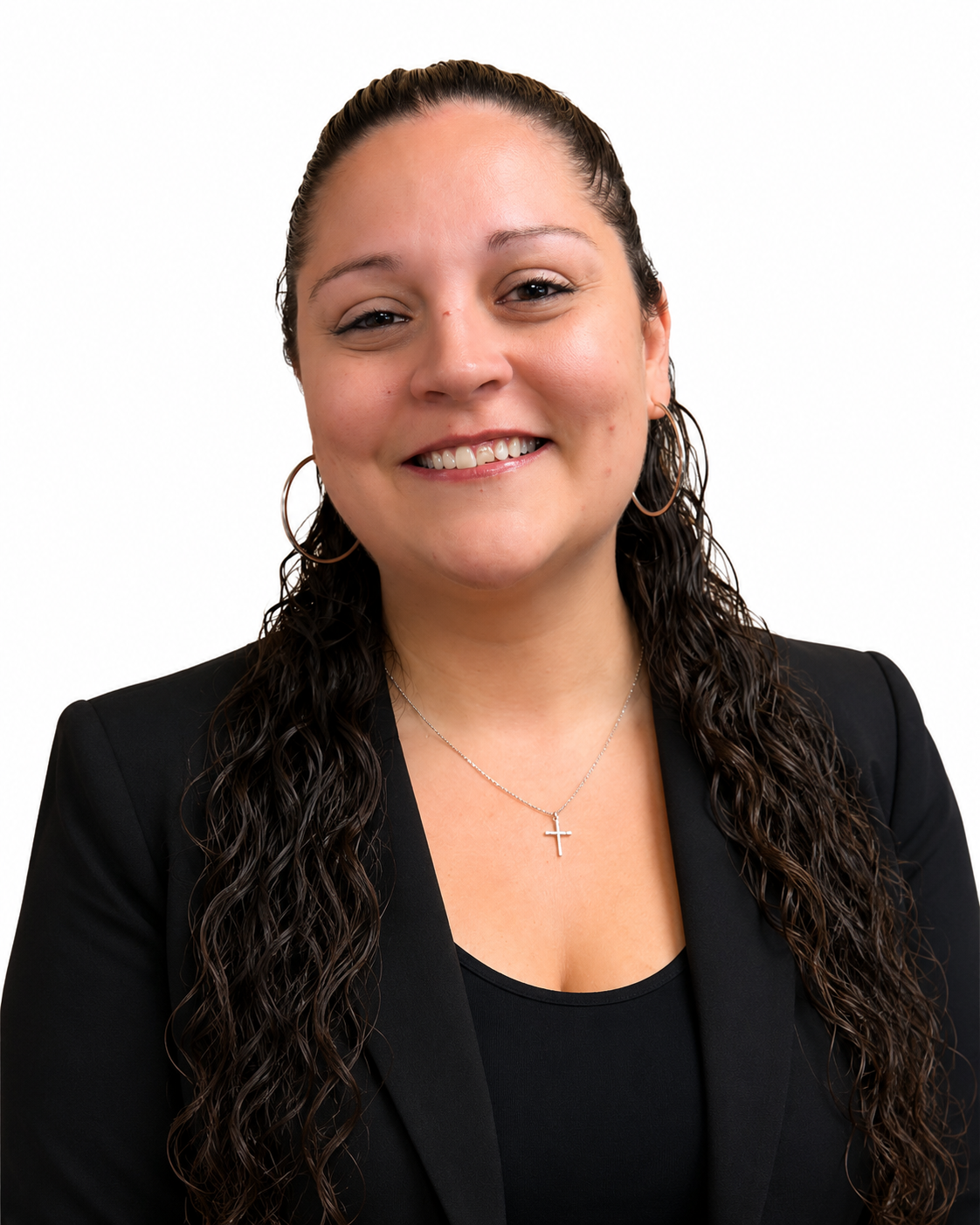Smiling person in a black blazer and top against a white background