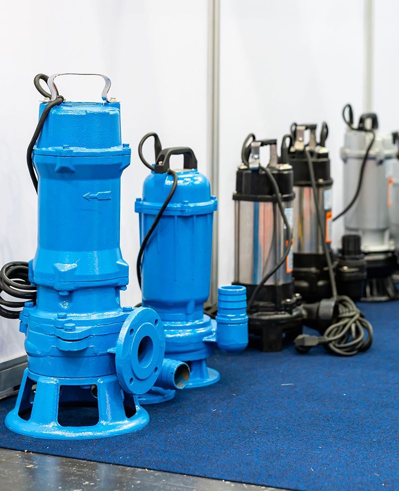 A row of blue water pumps are sitting on a blue carpet.