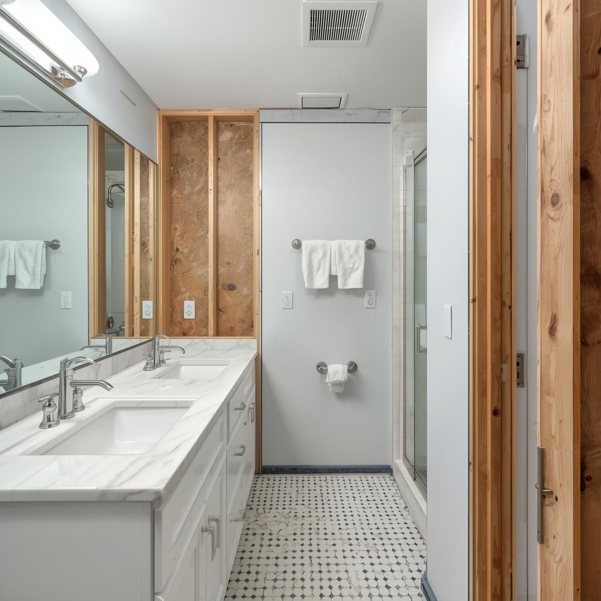Bathroom with a marble vanity, white cabinets, and a walk-in shower.