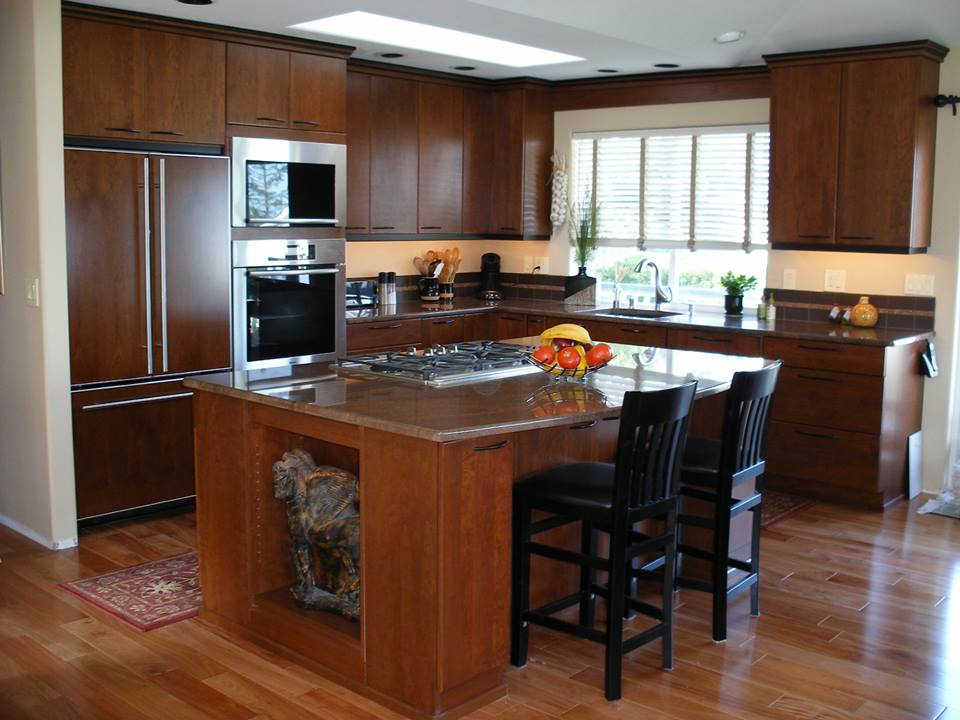 Modern kitchen with wood cabinets, central island, stainless appliances, and hardwood floors