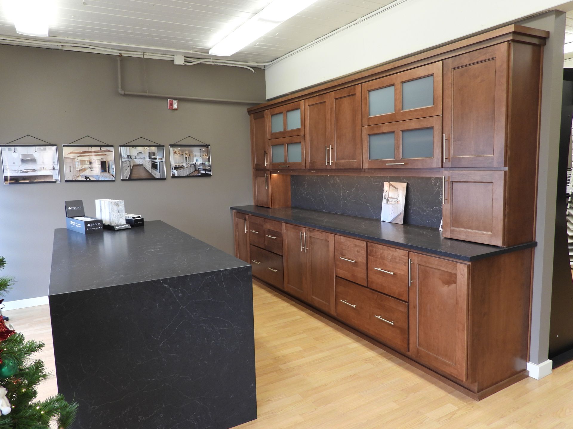 Kitchen with black island and large wooden cabinetry along the wall