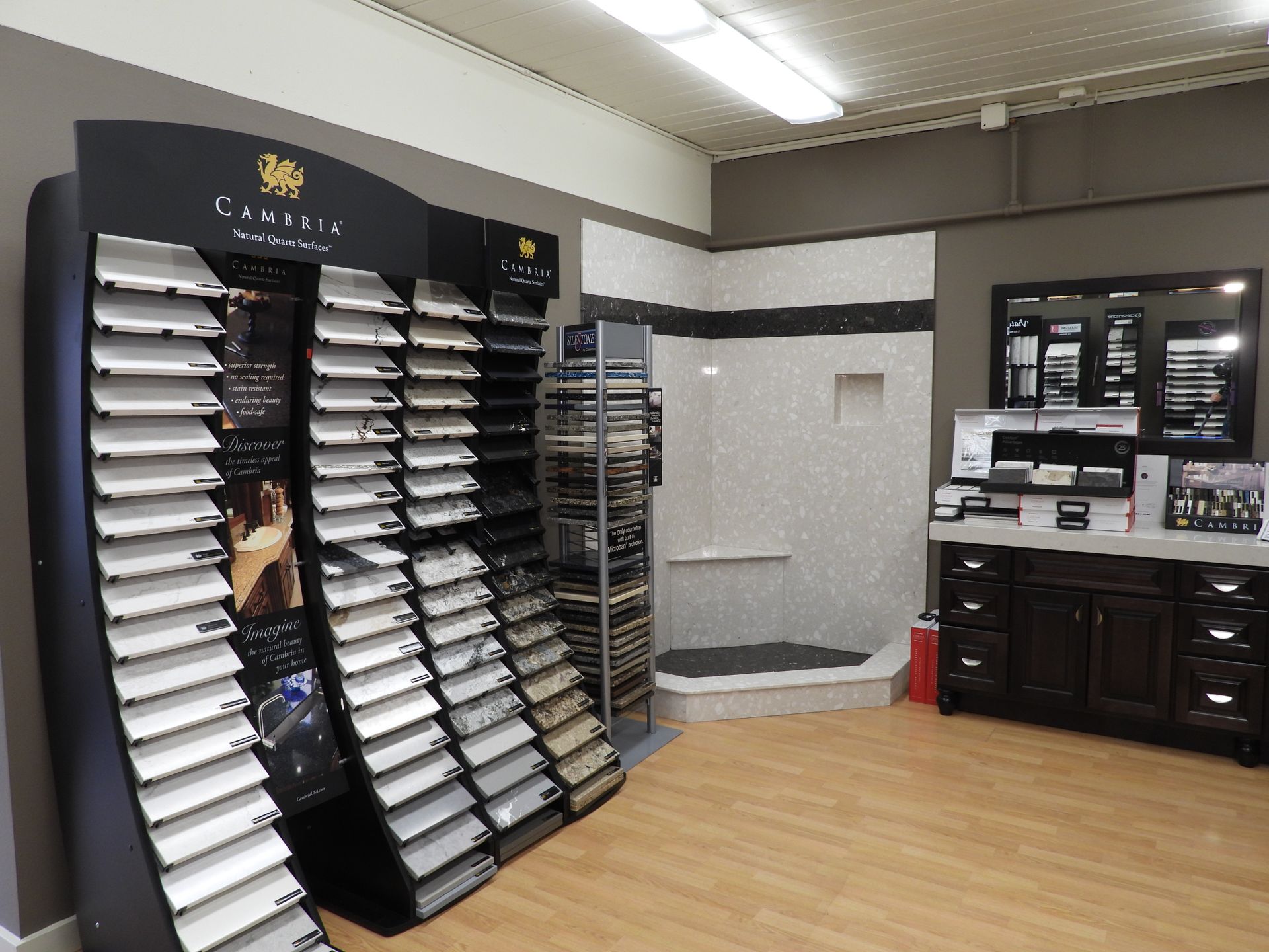 Car showroom interior with display racks of wheel or tire samples and a desk area