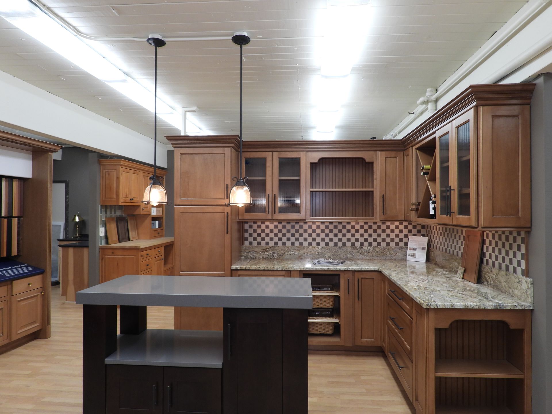 Modern kitchen with wood cabinets, granite counters, island, and pendant lights