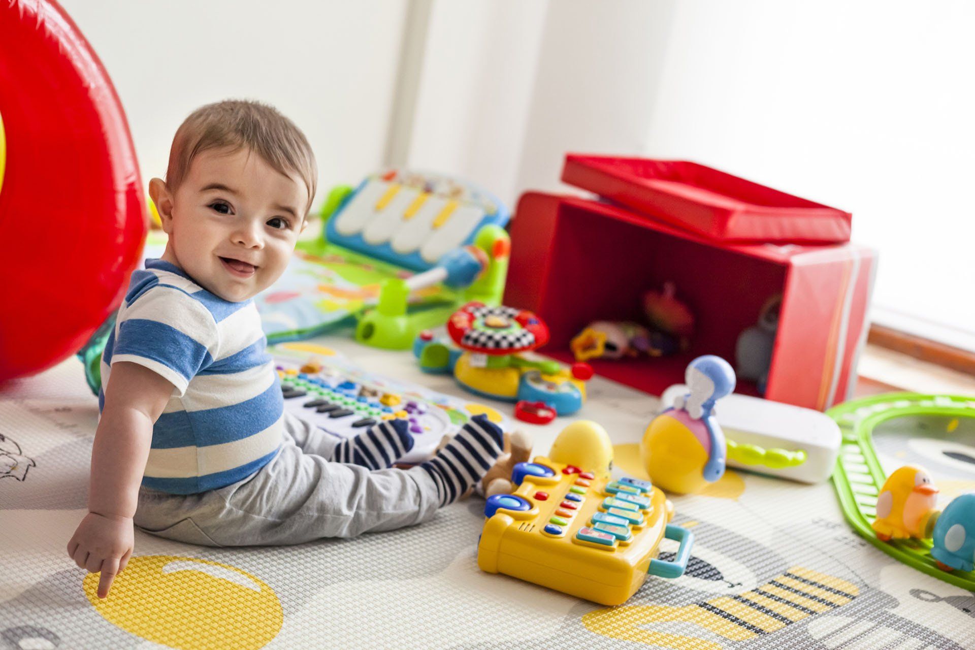 Baby Playing with Toys — Raymore, MO — Young Professors Daycare, LLC