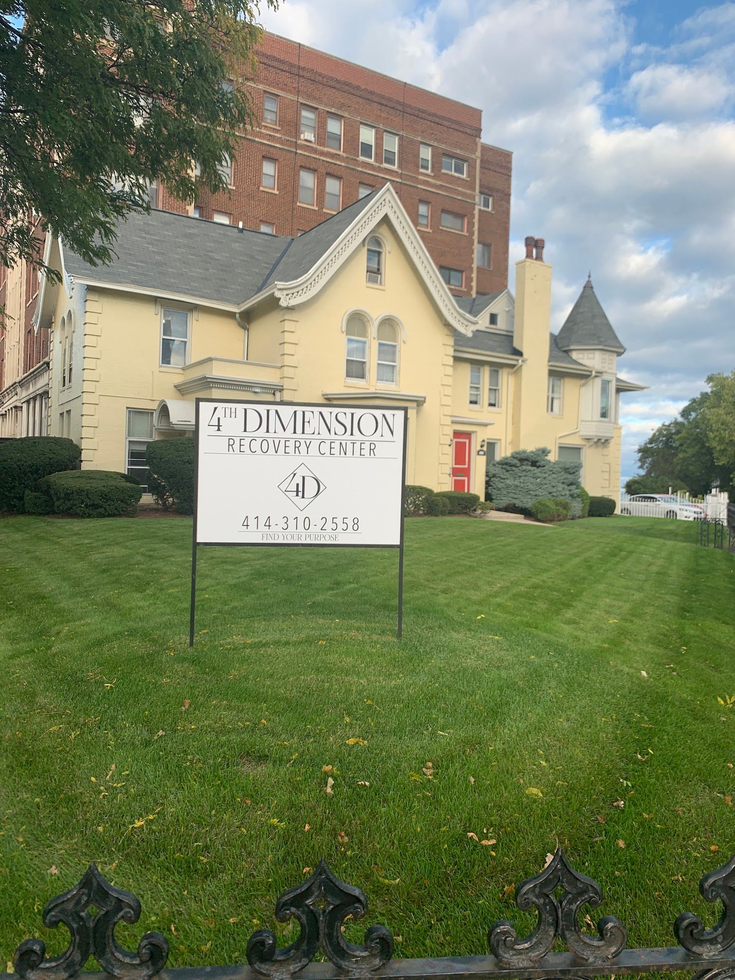 Yellow house with sign for 