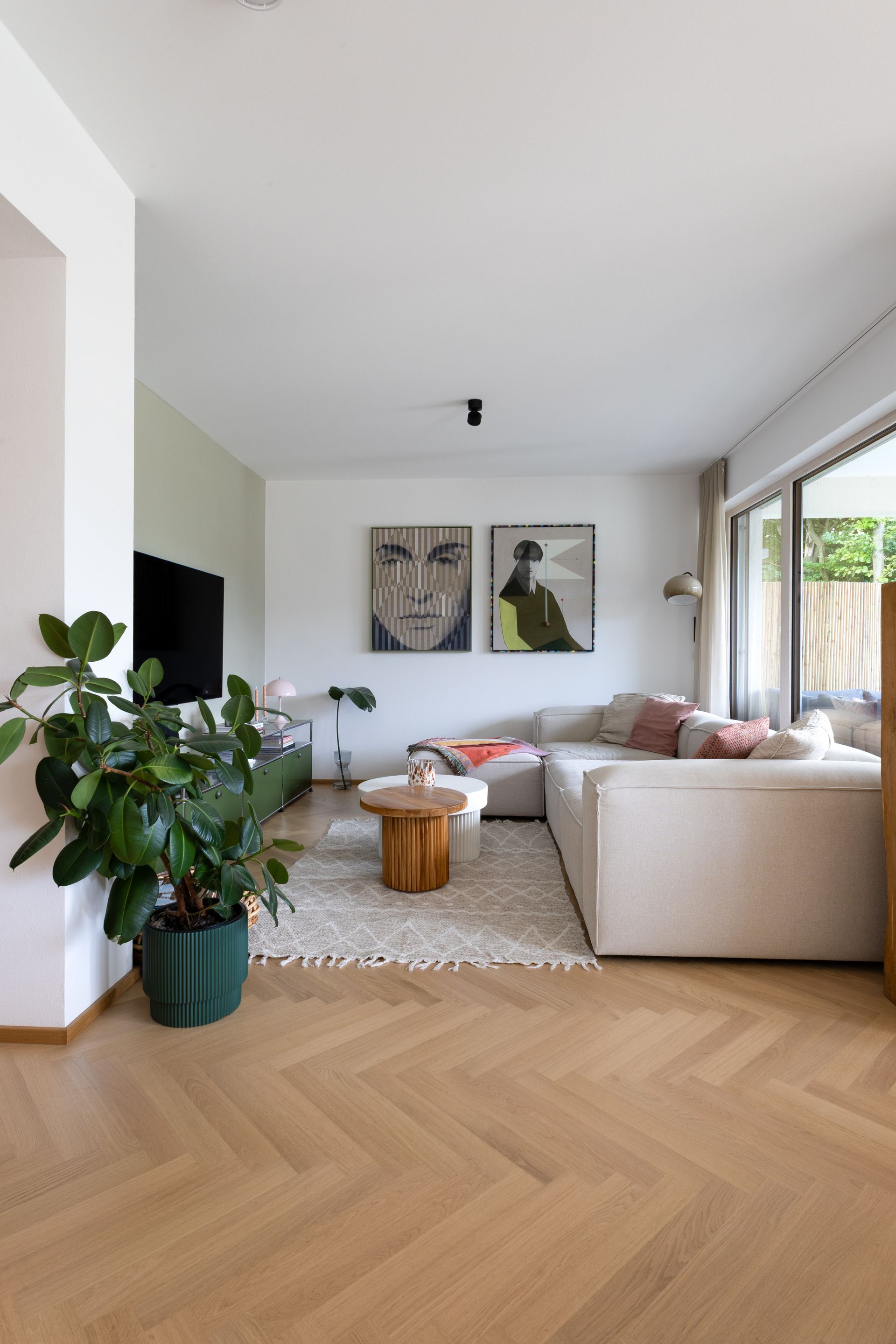 Wohnzimmer mit hellem Sofa, Fischgrätparkett, zwei Bilder und Zimmerpflanze.Fotograf Tübingen. Fotograf Reutlingen.