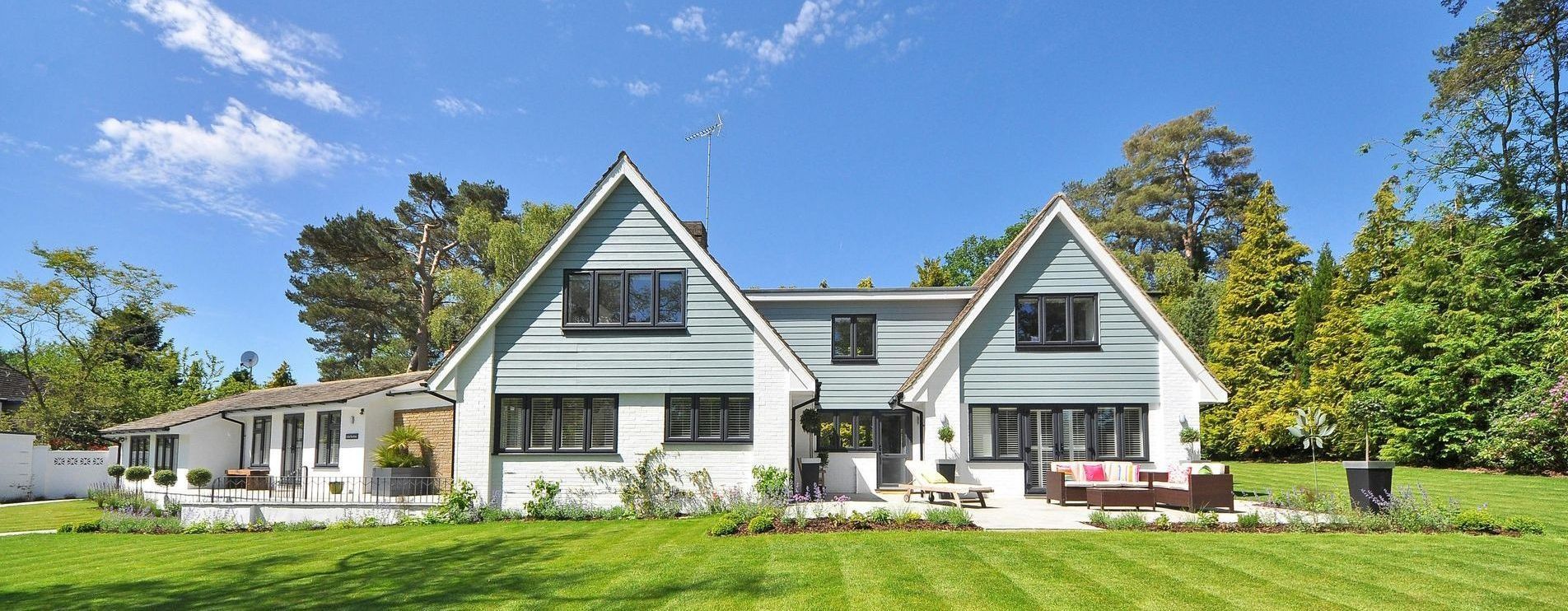 House with well manicured and landscaped lawn