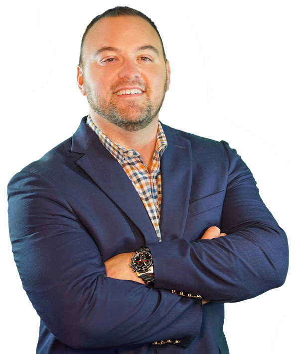 A man in a suit and plaid shirt with his arms crossed