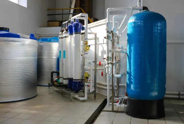 A room with a lot of pipes and tanks in it