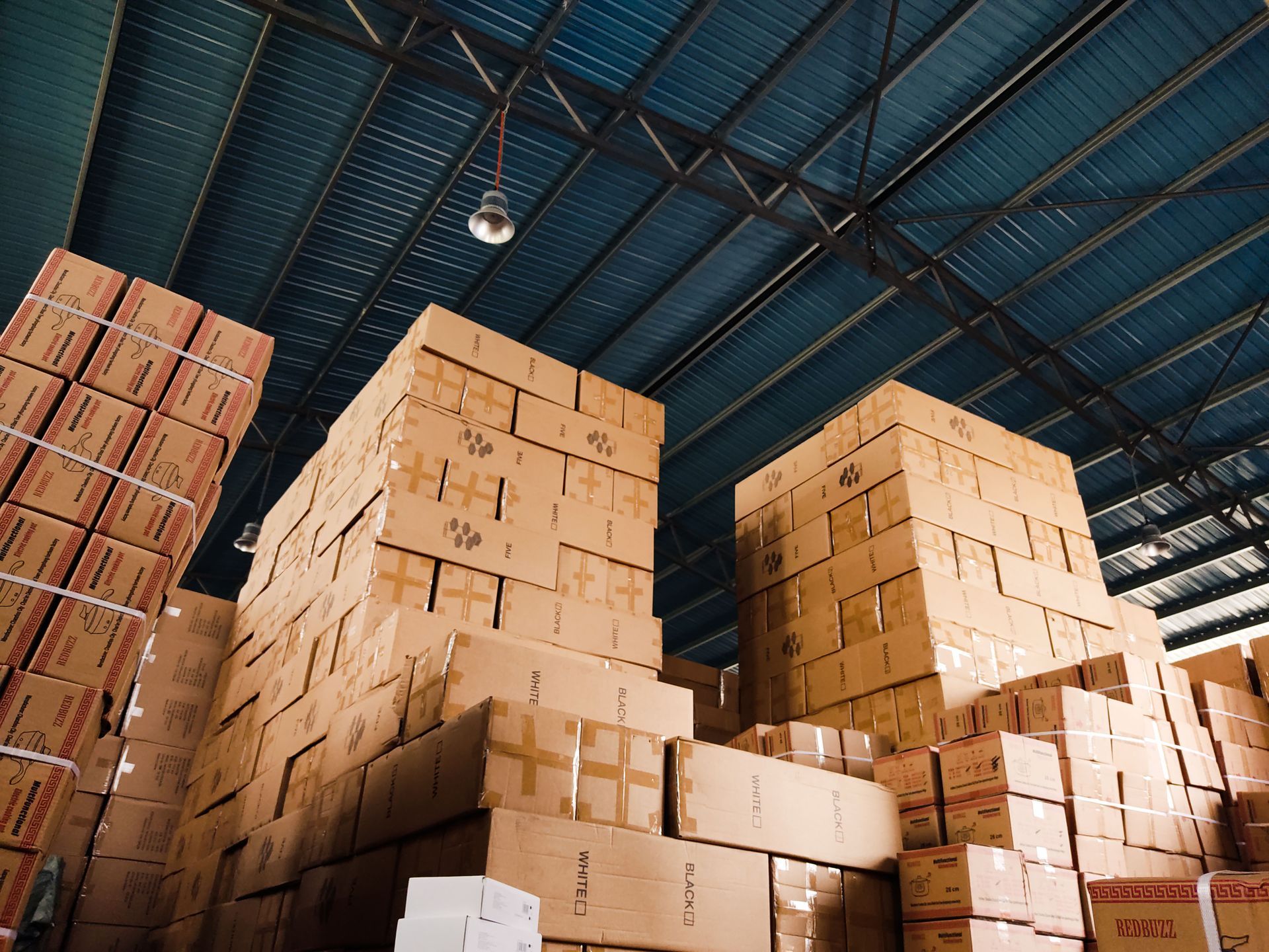 Stacks of cardboard boxes piled high in Square1 warehouse