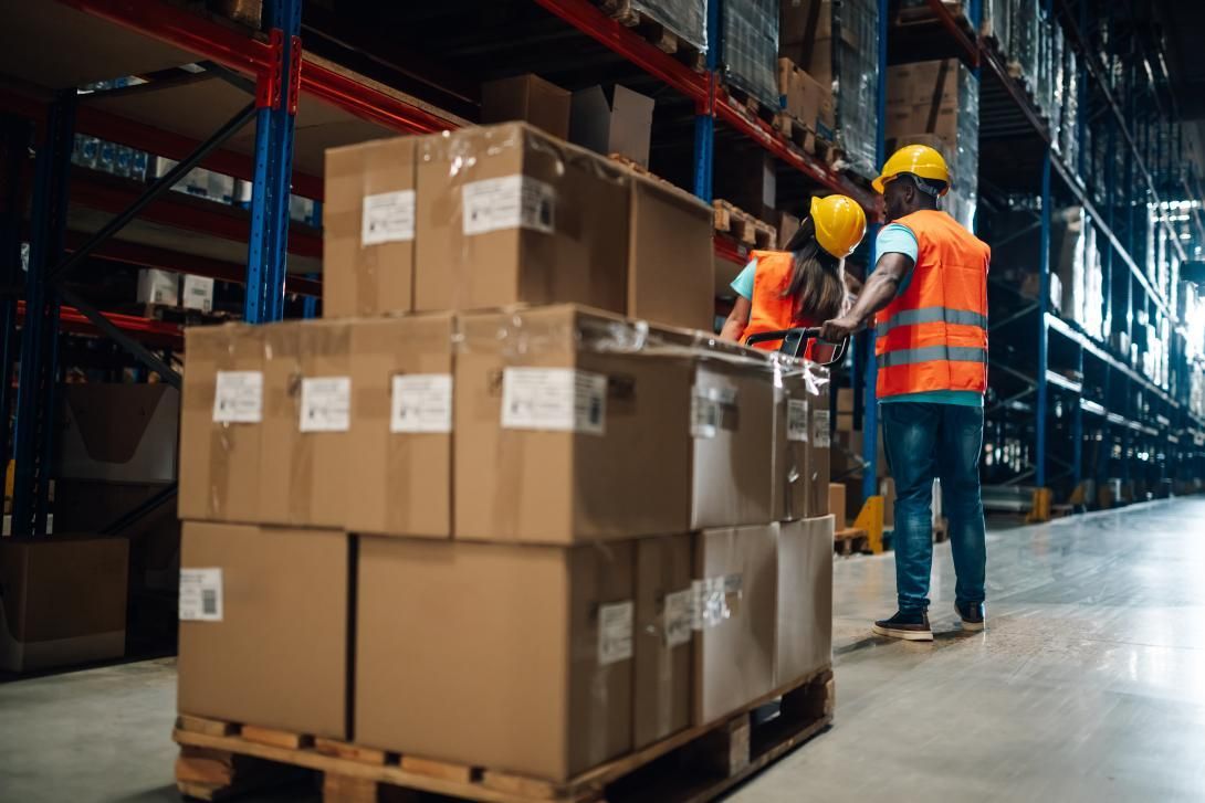 Packing small bottles into shipping box for ecommerce fulfillment and product packaging process