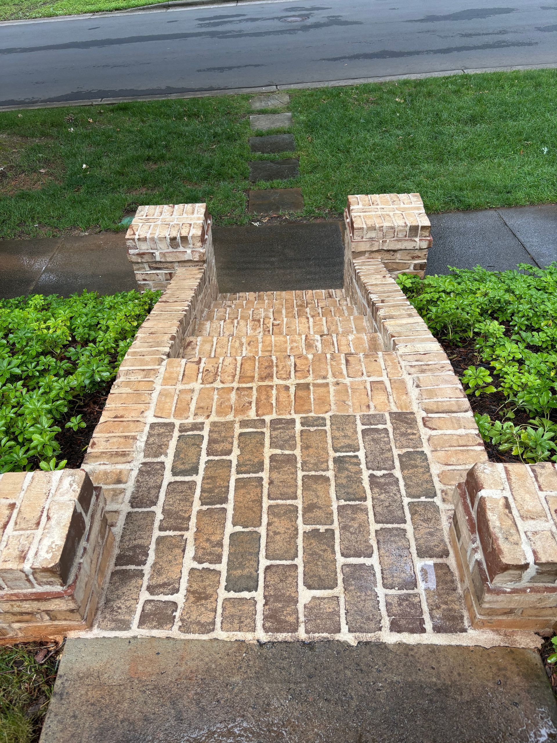 Windows Gutters LLC - Brick steps leading up to a home, with low brick walls on each side and a concrete landing.