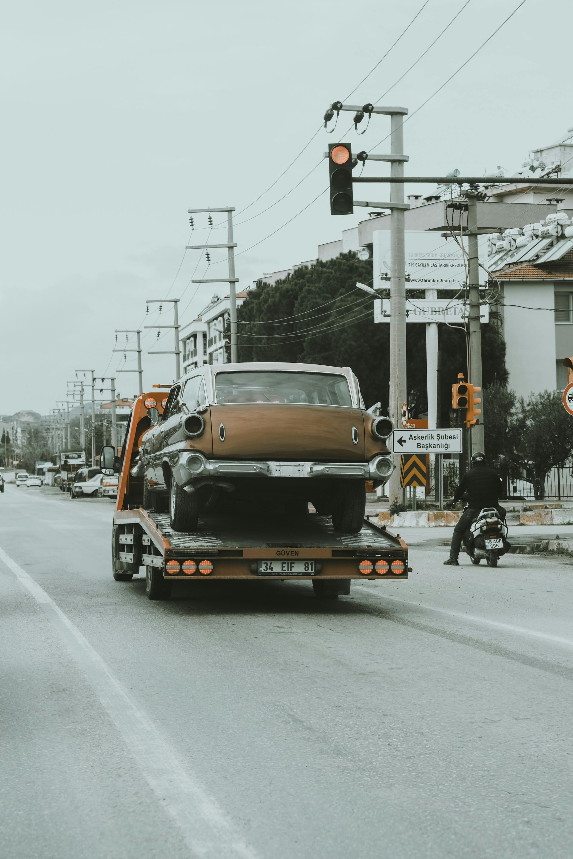 A tow truck is carrying a car