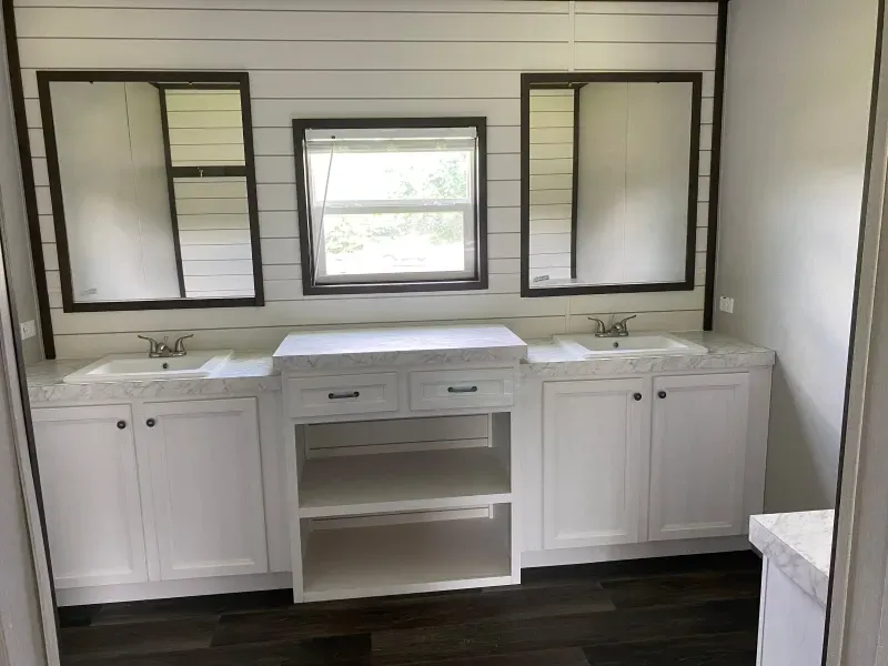 A bathroom with two sinks and two mirrors.