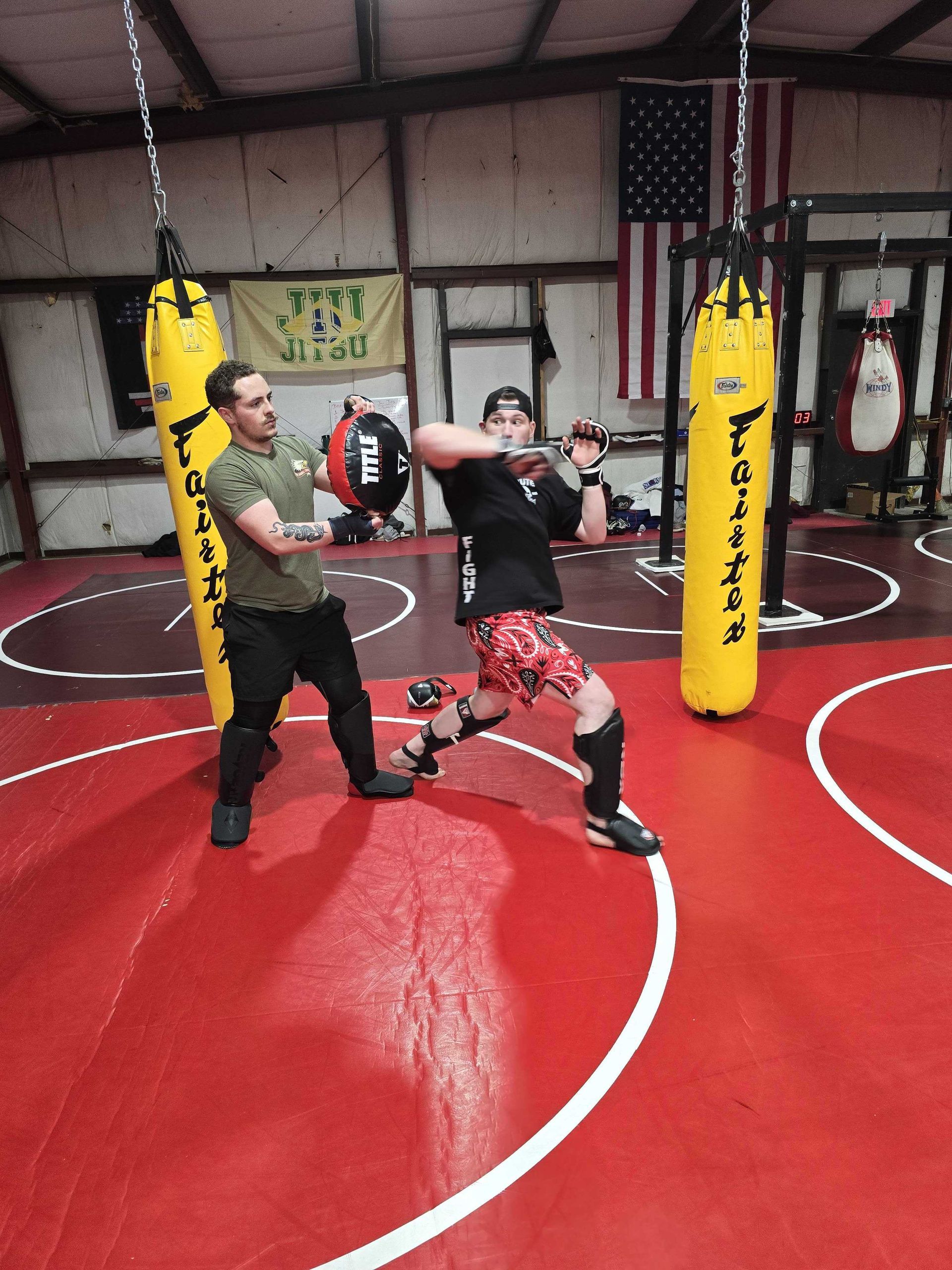 Adults practicing jiu jitsu positional control at Roberts Family Mixed Martial Arts in Orange, MA for real self-defense.