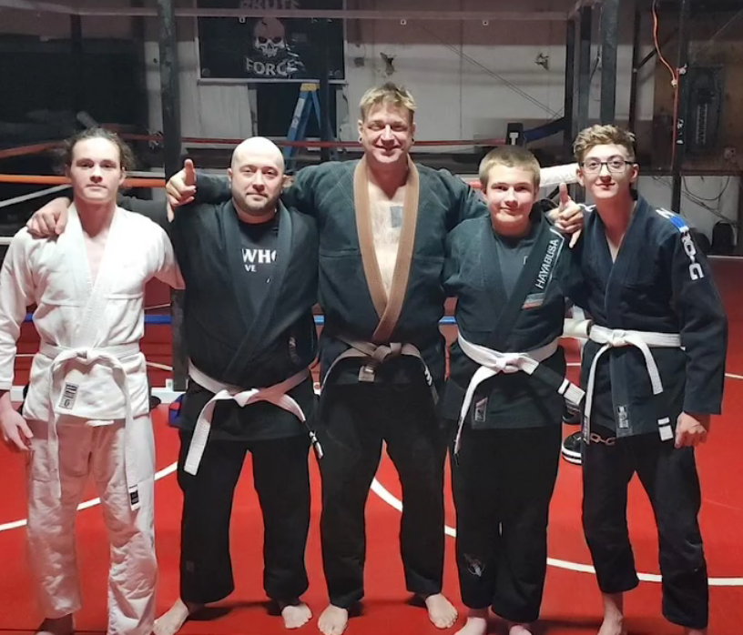 Adult students practice calm pad-work breathing at Roberts Family Mixed Martial Arts in Orange, MA for stress relief.