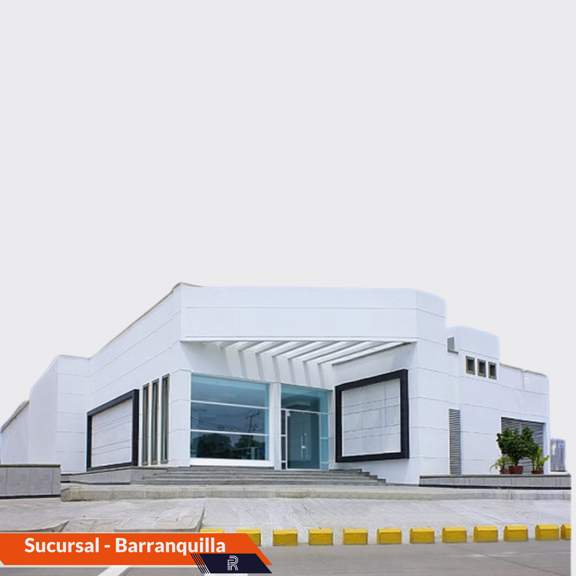 Edificio blanco con entrada de cristal, con la inscripción 
