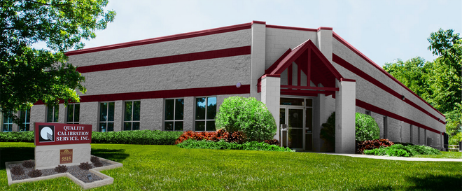 A Large Building With A Sign In Front — New Berlin, WI — Quality Calibration Services