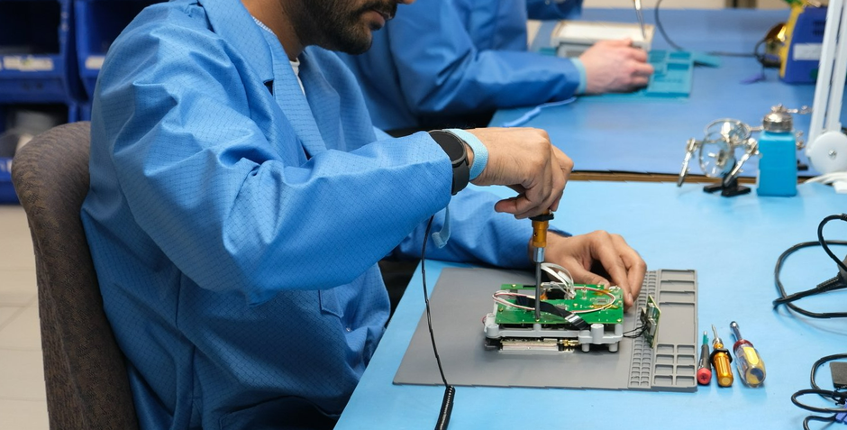 Engineering CPR technician assembling medical device electronics