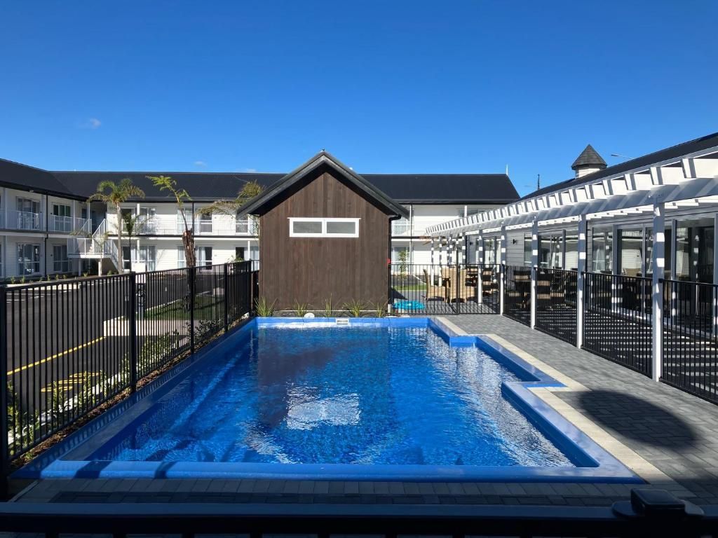 There is a large swimming pool in front of a building.