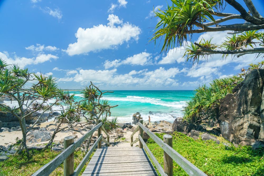 A Wooden Walkway Leading to the Ocean on a Sunny Day — Ontime Locksmiths & Security In Cabarita, NSW
