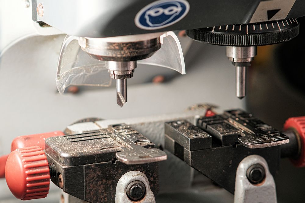 A Close Up of a Machine That is Cutting a Key — Ontime Locksmiths & Security In Ocean Shores, NSW