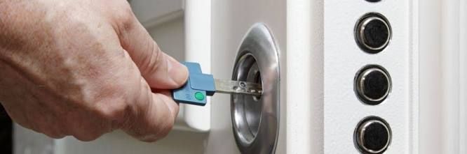Man Is Using A Blue Key To Open A Door — Ontime Locksmiths & Security In Byron Bay, NSW