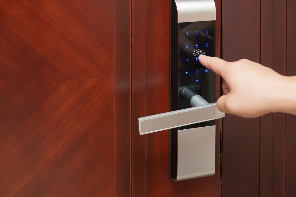 A Person is Pressing a Button on a Door Lock — Ontime Locksmiths & Security In Ocean Shores, NSW