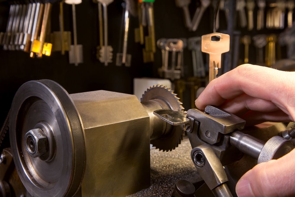 A Person is Cutting a Key With a Machine — Ontime Locksmiths & Security In Mullumbimby, NSW