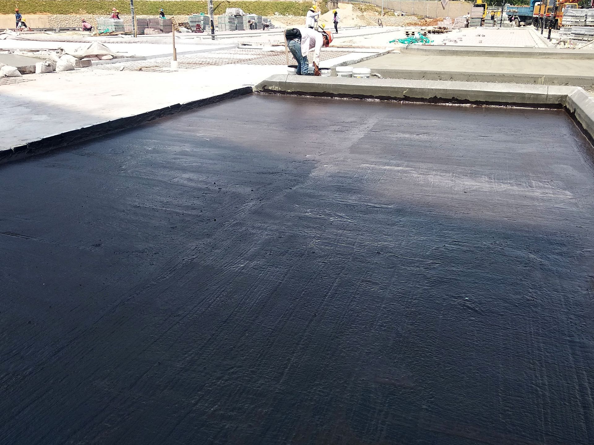 a man pouring cold fluid waterproofing