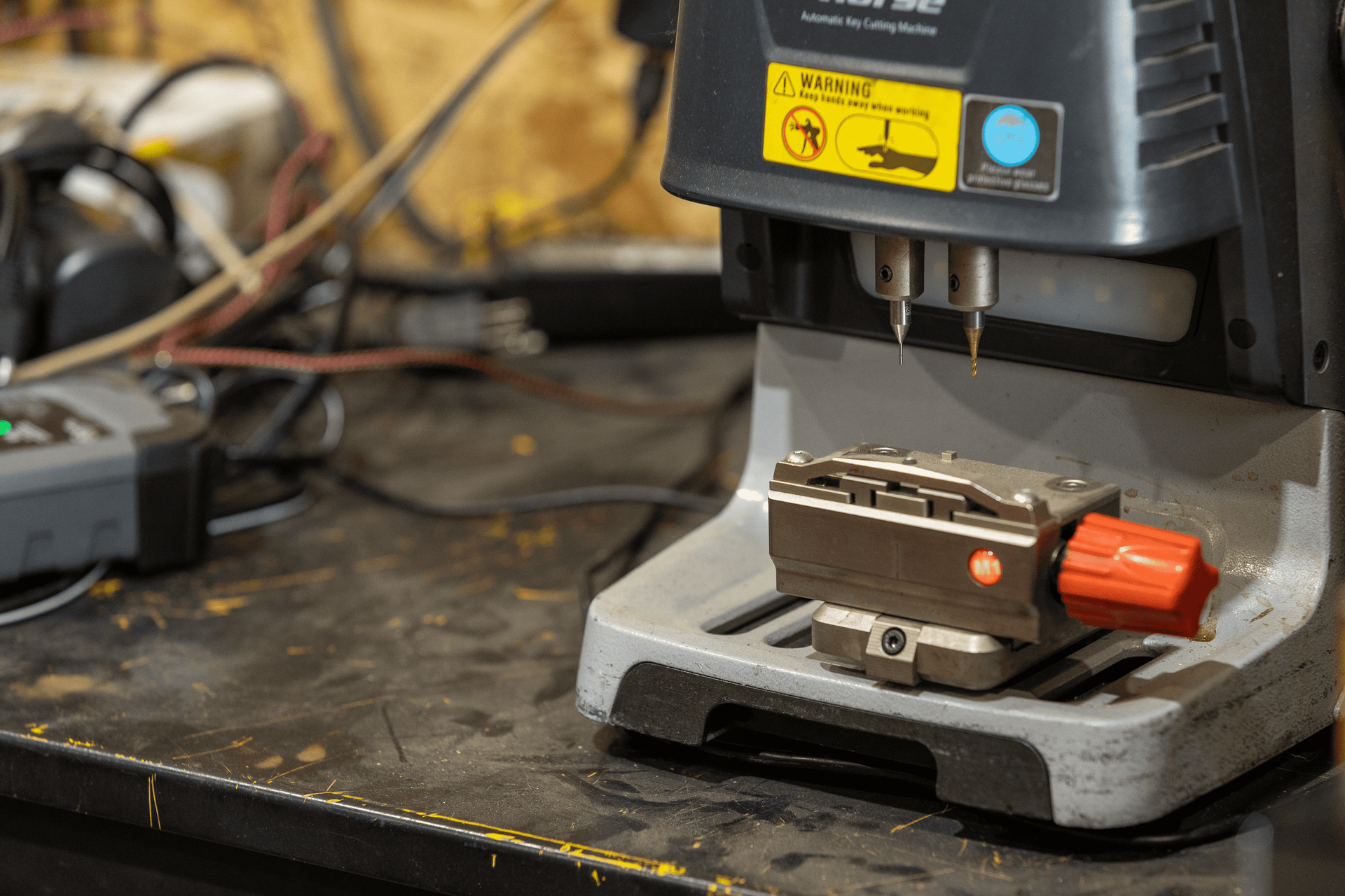 A key cutting machine is sitting on a table.