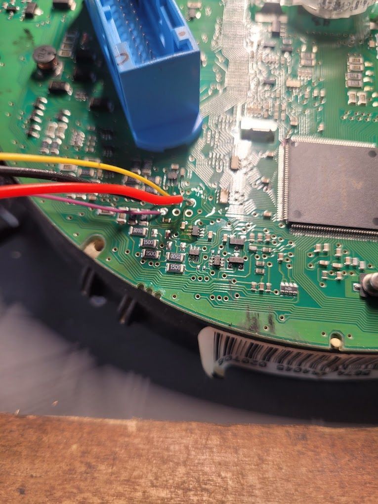 A close up of a motherboard with wires connected to it.
